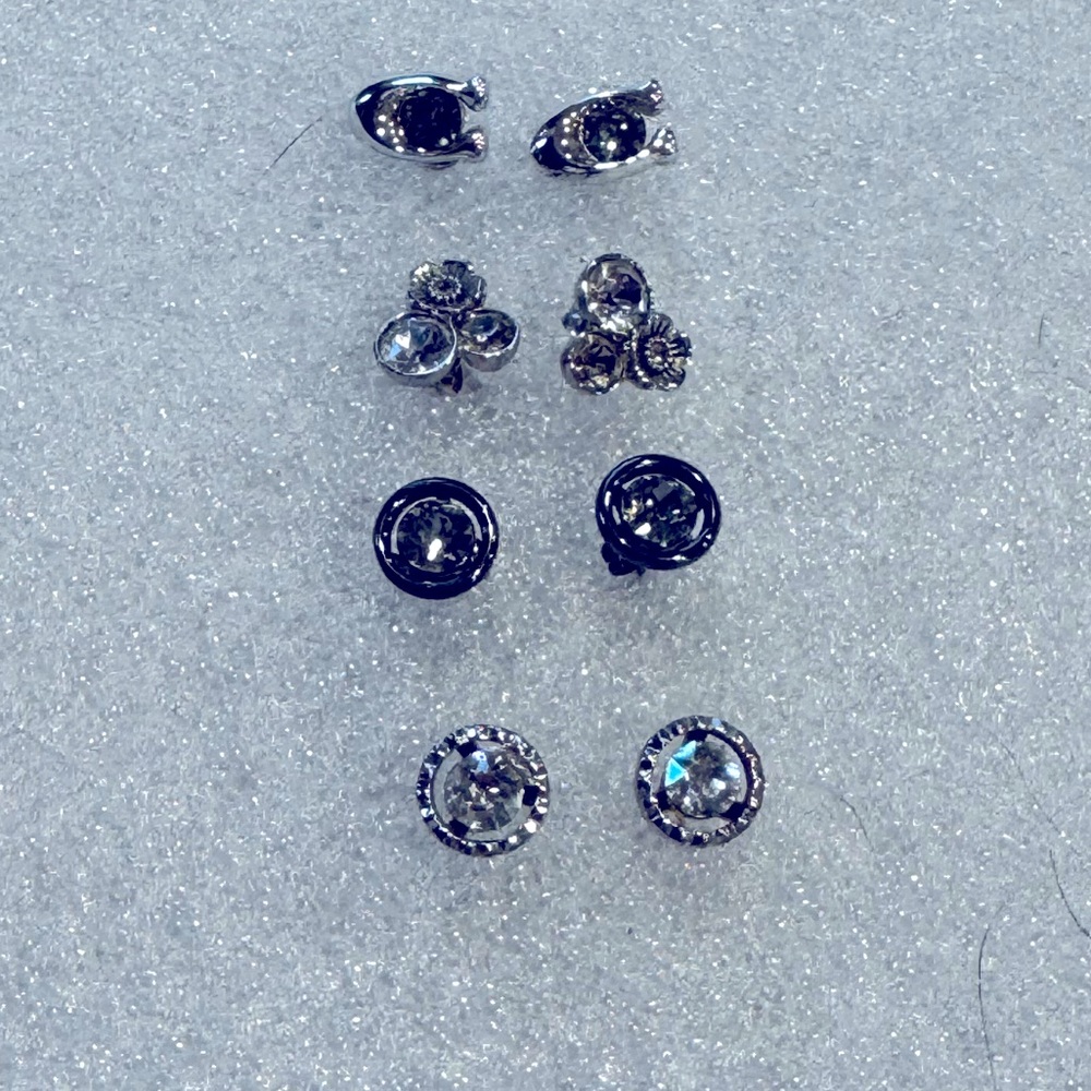 Coach 4 pair of stud earrings 3 silver stud sets and 1 black tone.